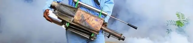 Fumigation technician using a fogger for deep pest treatment in Aurora, IL