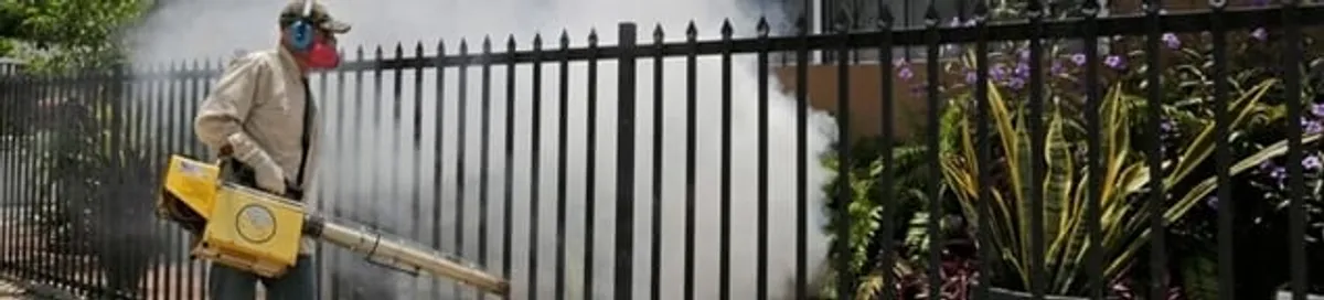 Mosquito control technician fogging a yard perimeter for mosquito reduction in Aurora, IL